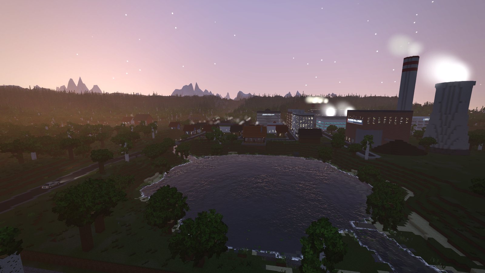 Dusk over Millbrook Lake, with the town lit up and the coal plant's stack and cooling tower steaming beyond
