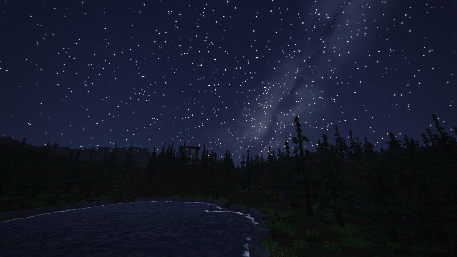 The Milky Way over Tamarack Lake at night, pines black against the stars